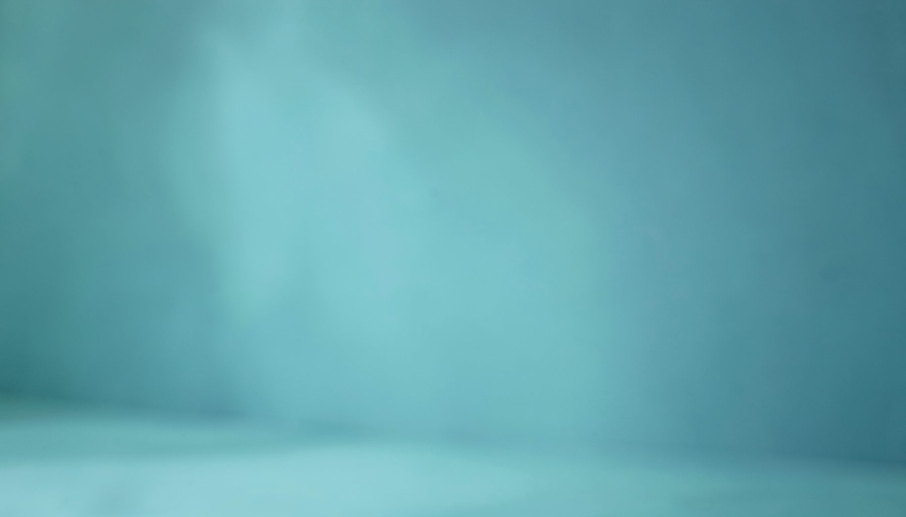 Soft teal and slate blue toned background suggesting a calm clinical setting, with gentle light and a quiet, reassuring mood